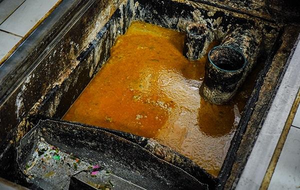 putting off grease trap cleaning can cause clogs, foul odors, and even fines from local authorities